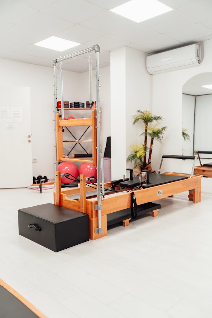 A spacious pilates room featuring high-quality equipment for a perfect workout.